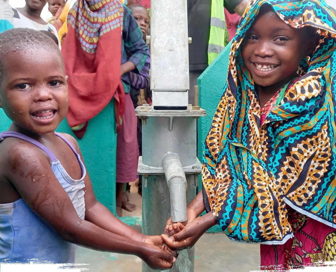 "Children in african village drinking from a water well"